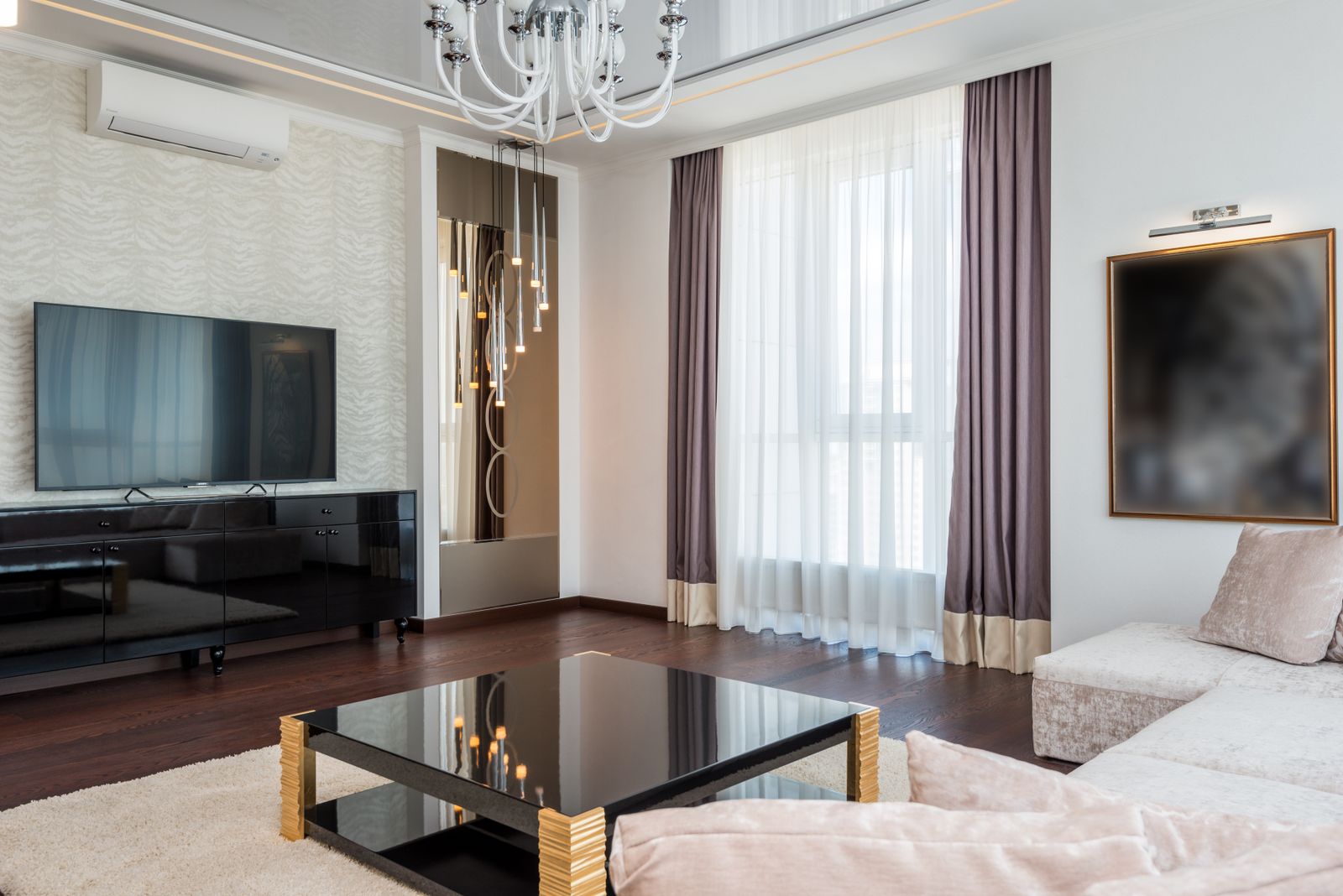 A staged great room with the doors open to the garden